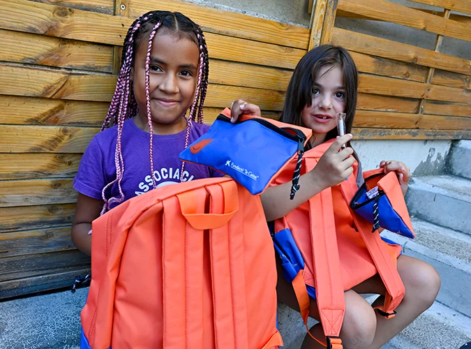 Duas meninas beneficiárias do programa CaixaProinfància com o seu novo material escolar © Fundação ”la Caixa”